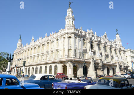 La Habana, Cuba - 7 january 2016: people driving colored vintage American cars on the street in front of the Galician Palace on Stock Photo