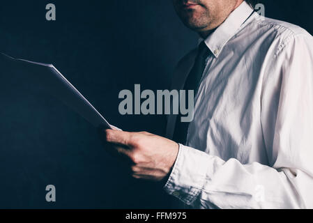 Tax inspector doing financial auditing, businessman reading business report, retro toned, selective focus Stock Photo