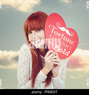 Composite image of smiling hipster woman with a big red heart Stock Photo