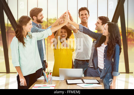 Composite image of group of young colleagues using laptop Stock Photo