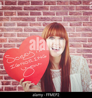 Woman holding a heart shaped sign in her hands Stock Photo