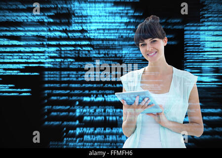 Composite image of happy woman using tablet Stock Photo