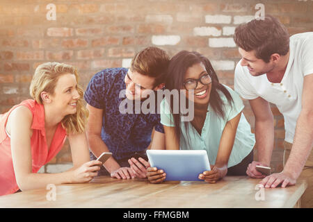 Composite image of creative team all using smartphones Stock Photo