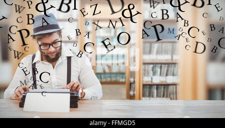 Composite image of hipster wearing eye glasses and hat working on typewriter Stock Photo