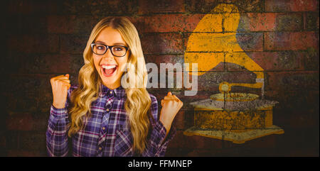Composite image of gorgeous blonde hipster celebrating success Stock Photo