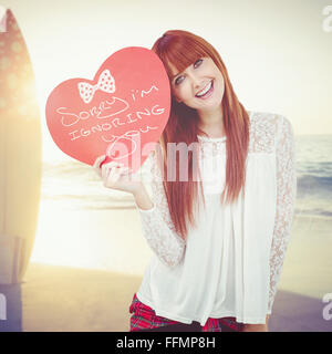 Woman holding a heart shaped sign in her hands Stock Photo