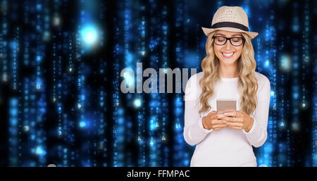 Composite image of gorgeous smiling blonde hipster using smartphone Stock Photo