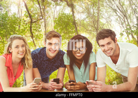 Composite image of creative team all using smartphones Stock Photo