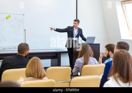 Speaker giving presentation at business conference in meeting hall Stock Photo