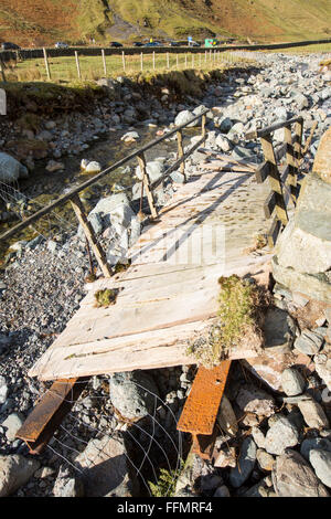 Storm Desmond wreaked havoc across Cumbria with floods and destruction, here a footbridge has been swept sideways and destroyed Stock Photo