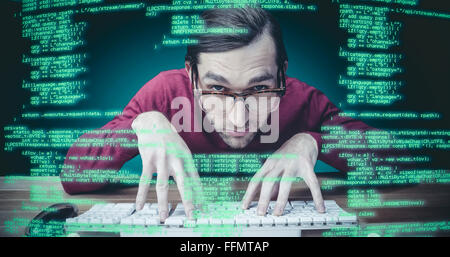 Composite image of man wearing eye glasses typing on computer keyboard Stock Photo