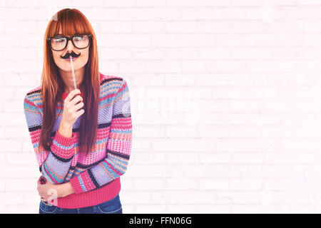 Composite image of smiling hipster woman with a mustache Stock Photo