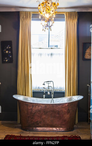 Artist Alice Instone's house in Clapham, London. The copper bath in the master bedroom. Stock Photo