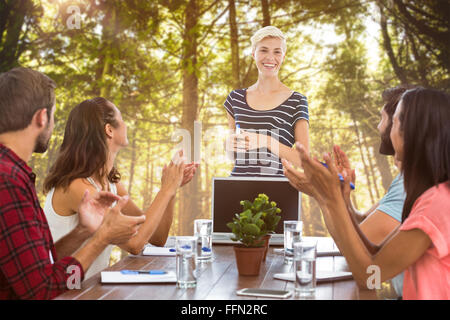 Composite image of colleagues clapping hands in a meeting Stock Photo