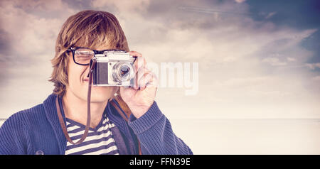 Composite image of hipster taking pictures with an old camera Stock Photo