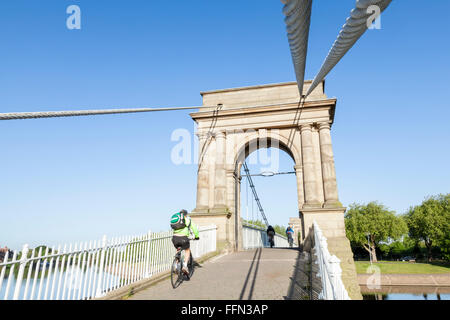 Cyclists on Wilford Suspension Bridge crossing the River Trent, Nottingham, England, UK Stock Photo