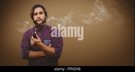 Composite image of portrait of confident hipster holding smoking pipe Stock Photo