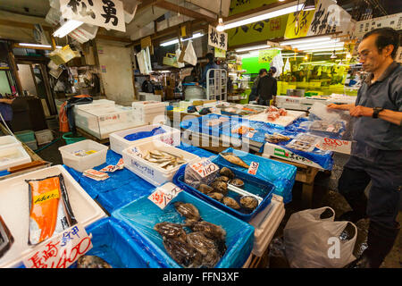 TOKYO - MAY 11: Shoppers visit Tsukiji Fish Market on May 11, 2014 in Tokyo. It is the biggest wholesale fish and seafood market Stock Photo