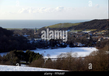 Looking down on Llanrhystud, Ceredigion, showing the nineteenth century church and the golf course under snow. Stock Photo