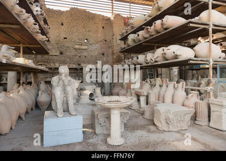 Earthenware pots and the cast of a person recovered from the ruins in Pompeii, Italy, Europe Stock Photo