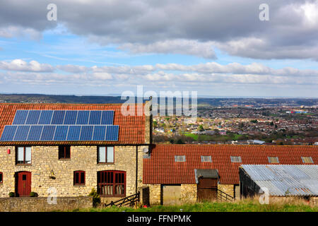 Farmhouse building with photovoltaic panels on roof, overlooking Bristol Stock Photo