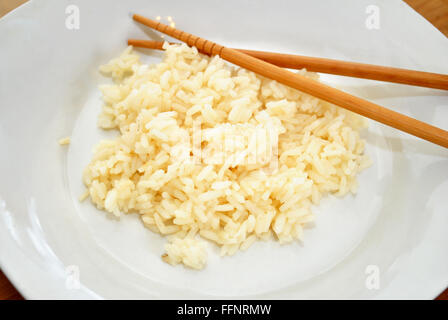 White Rice with Chop Sticks on a Plate Stock Photo