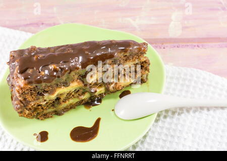 Delicious chocolate cake with walnuts on a green plate Stock Photo