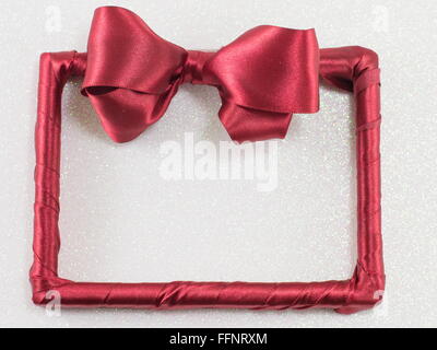 empty picture frame with red ribbon on white background Stock Photo