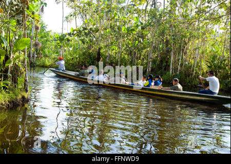 Boat with visitors touring the Amazon River in Ecuador Stock Photo