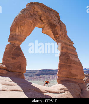 A couple kissing under Delicate Arch in  the Arches National Park Stock Photo