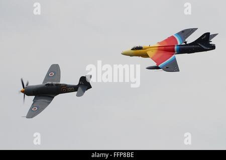 An interesting formation of two Hawker classics, the propeller driven Sea Fury and the subsonic Hunter jet.  East Fortune 2013. Stock Photo