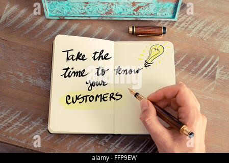 Handwritten text TAKE THE TIME TO KNOW YOUR CUSTOMERS next to yellow lighting bulb as symbol for bright idea. Stock Photo