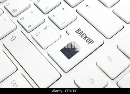 Backup safety storage technology concept. Hard disk button or key on white keyboard Stock Photo
