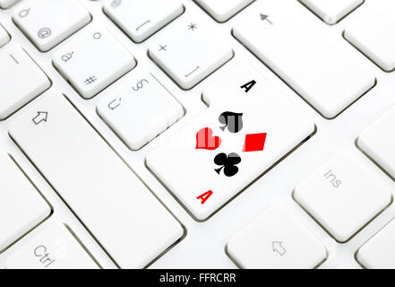 Poker or Casino online game concept. Spades hearts diamonds clubs key on white keyboard Stock Photo