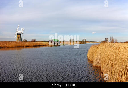 A view of the River Thurne with St Benet's Level Drainage Mill on the Norfolk Broads at Thurne, Norfolk, England, UK. Stock Photo