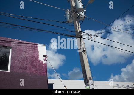 Current overhead line and a house is painted purple Stock Photo