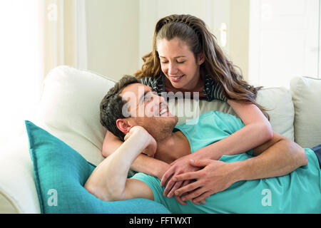 Young couple embracing on sofa Stock Photo