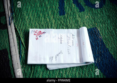 Migrants on Chios Island -  04/01/2016  -  Greece / Cyclades (the) / Chios island  -  Notebook forgotten on a mat in UNHCR hot s Stock Photo