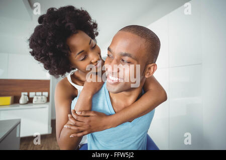 Handsome man giving piggy back to his girlfriend Stock Photo