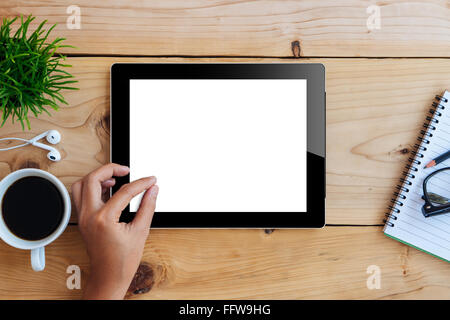 hand using mockup tablet on wood desk white display with clipping path screen easy add image Stock Photo