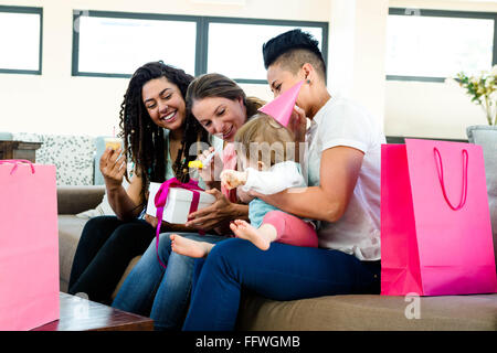 Three women celebrating a babies first birthday Stock Photo