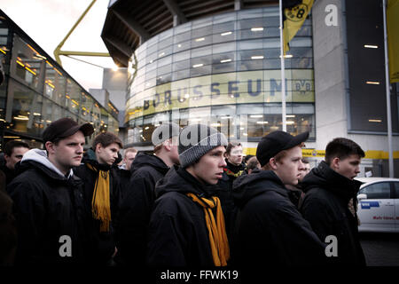 Borussia Dortmund 1-1 Fortuna Dussledorf, Signa Iduna Park, Dortmund. Young 'Ultras' wait to collect flags, banners and protest leaflet from the 'Fan Project' which provides support for all fans at the club. The South Stand, 'Yellow Wall,' which is an all standing terrace. Stock Photo