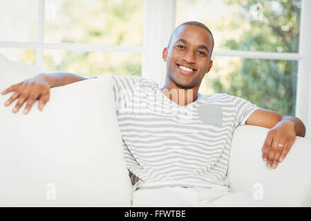 Handsome man sitting on the sofa Stock Photo