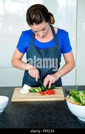 woman preparing sliced vegetables for dinner Stock Photo