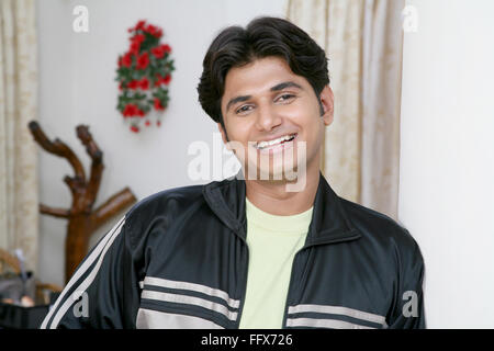 young man resting to the pillar and smiling  MR # 687C Stock Photo