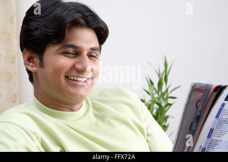young man reading and smiling  MR # No687C Stock Photo