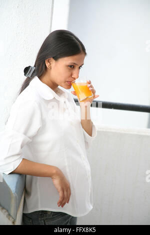 South Asian Indian young pregnant married lady drinking fruit juice MR#687 Q Stock Photo