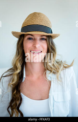 brunette woman wearing a woven straw hat Stock Photo