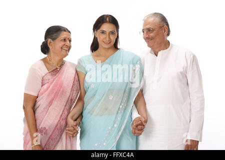 Young woman standing between old couple holding hands MR#703P,703Q,703S