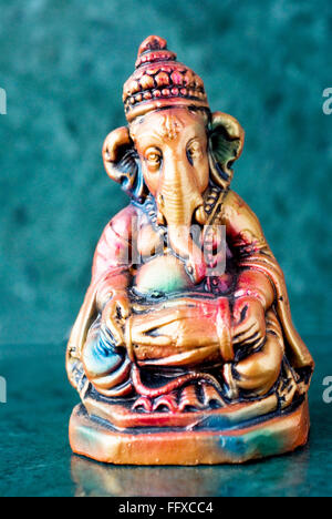 Lord Ganesha ganpati plaster Idol sitting colourful playing mrudungam timpani Indian musical instrument Stock Photo